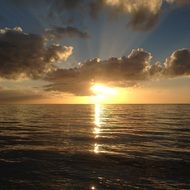 scenic sunset behind the clouds over the ocean
