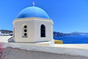 cute blue building in santorini beach