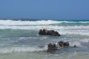 landscape of rocks on the shore in the waves