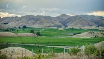 landscape of green fields and mountain roads