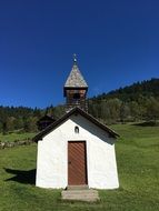 white chapel on a background of green Alpine mountains, germany