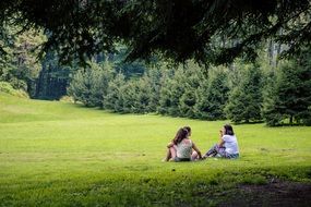 two girls on a picnic among beautiful nature