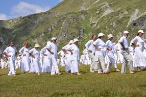 dancing people in white suits on the mountain in Bulgaria