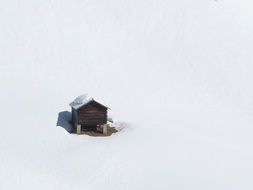 landscape of lonely hut in snow in dolomites