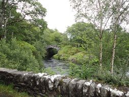 stone bridge over river in scotland