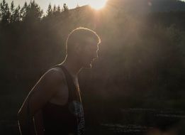 Young man near the lake during sunset