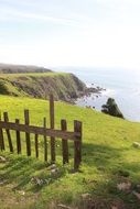 wooden fence on the slope near the sea