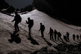 climbers go to the top of the mountain at night