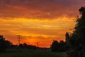 landscape of beautiful orange sunset over the field