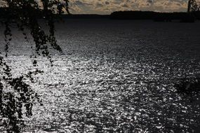 dark glossy lake at stormy weather