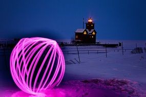 glowing ball on the background of the lighthouse