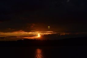 golden sunset and black clouds on the horizon