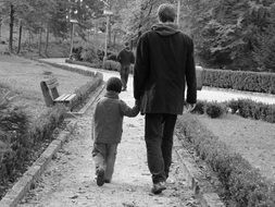 father and son walking black and white shoot