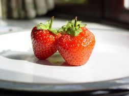 ripe strawberries on the white plate