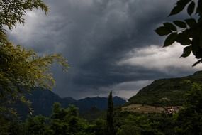 dark rain clouds over the mountains
