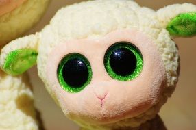 plush sheep with green eyes