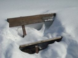 wooden bench in snow