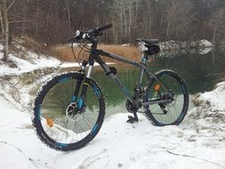 mountain bike stands in the snow