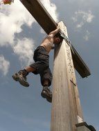 man on top of the cross