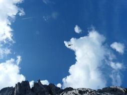 Helicopter under the clouds in the sky