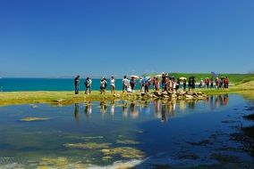 people taking photos on scenic coast, taiwan, penghu