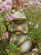 ceramic figure of a frog in the garden