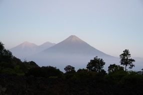 distant view of volcanoes in the haze