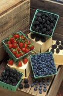 boxes with blackberries, blueberries and strawberries