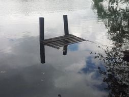 reflection of white clouds in a lake