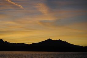 sunset behind the mountain near the lake