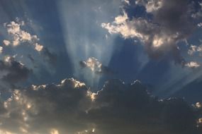 bright sunbeams in gray clouds