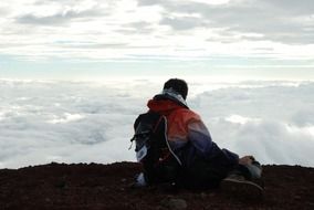 man sits on top of a mountain