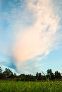 big cloud over green meadow