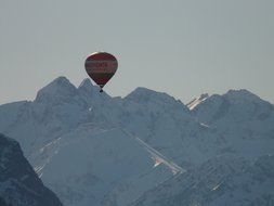 hot air balloonat sky above scenic mountains