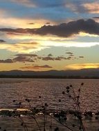 lake during sunset under the sky with clouds