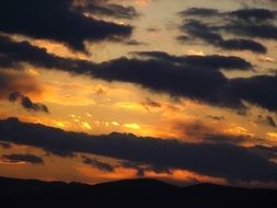 dark clouds burning sunset