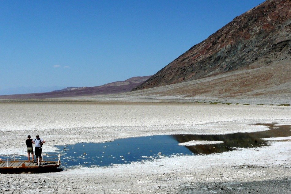people near a pond in the valley of death in California