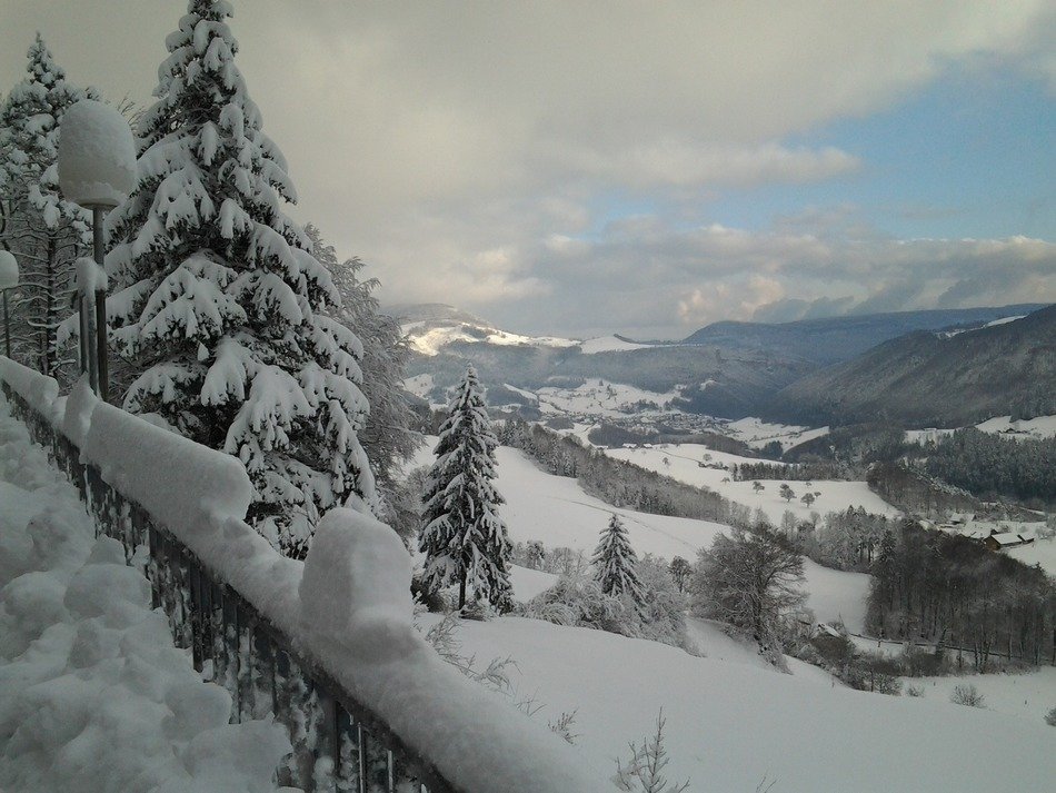 snow-covered landscapes with hills in jura in eastern france