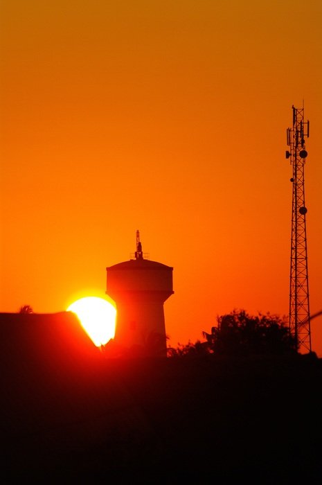 water and radio tower sunset