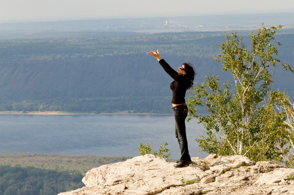 the girl on the rock hands up