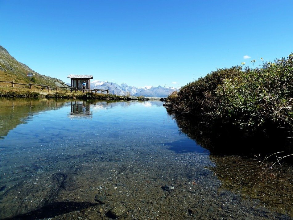 stones in the water near the mountains