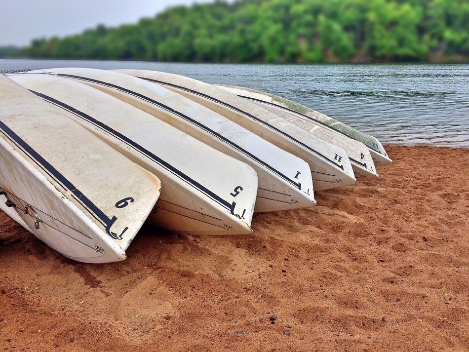white boats in the sand on the beach