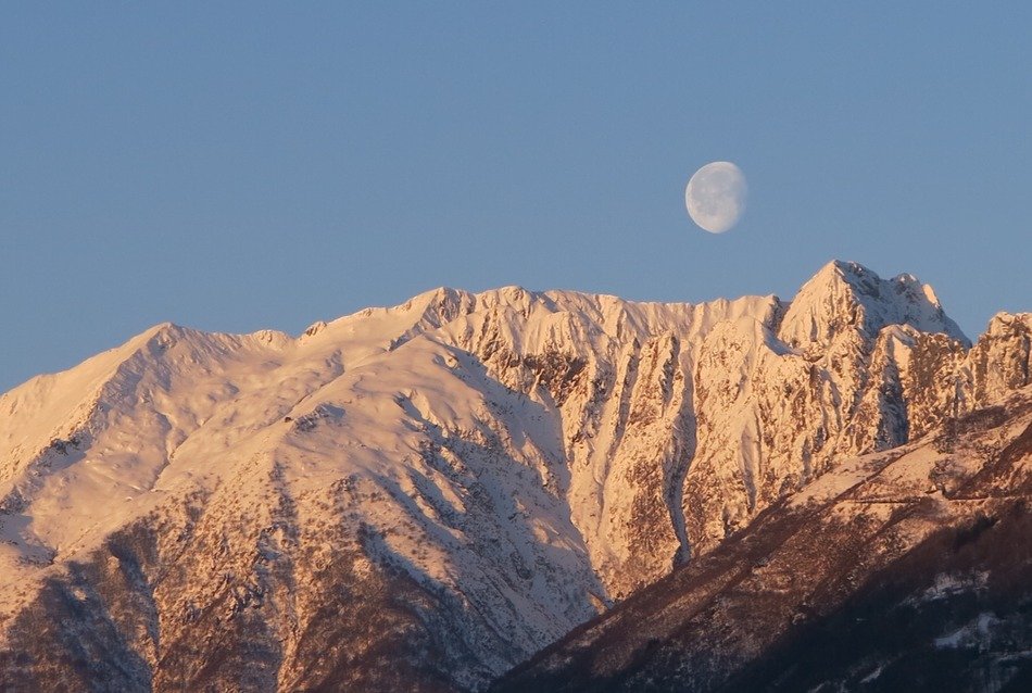 moon in the blue sky over the mountain