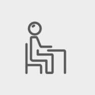 Student sitting on a chair in front of his table N8
