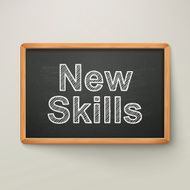 new skills on blackboard in wooden frame