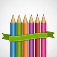 Colorful pencils with green ribbon