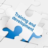 training and development on white puzzle pieces