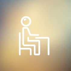 Student sitting on a chair in front of his table N9