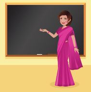 Indian woman teacher in saree front of a blackboard