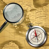 Magnifying glass and compass over old map